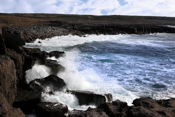 wave crashing on coast cliffs