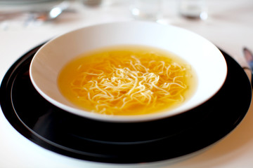 Soup with noodles made of beef and vegetables, plated