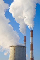 Industrial landscape with pipes against the blue sky
