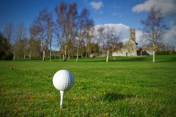 Golf ball on the tee - idyllic golf course of irish Adare