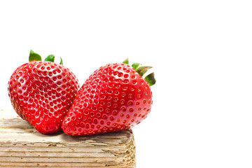 group of strawberries over a piece of old wood