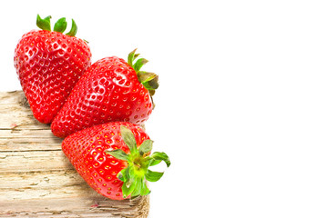 group of strawberries over a piece of old wood