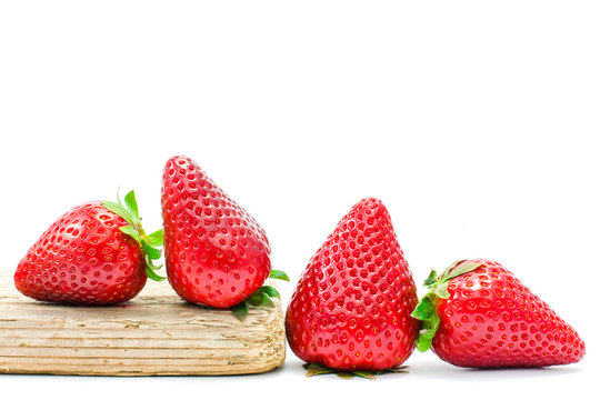group of strawberries over a piece of old wood