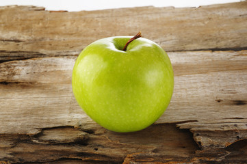one green apple on wood background
