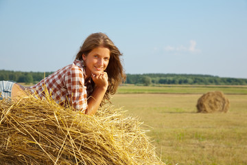 Naklejka na ściany i meble girl enjoying on hay