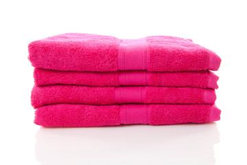Obraz na płótnie Canvas pile of pink towels over white background