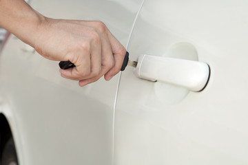 Person Inserting Car Key in door lock