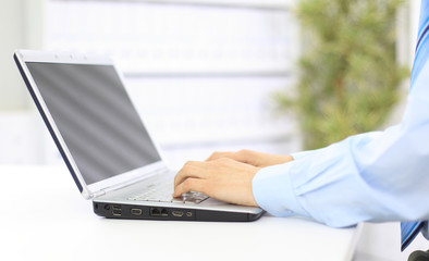 Person Typing on a modern laptop in an office