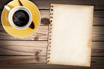 Old note paper on wood table with a cub of coffee