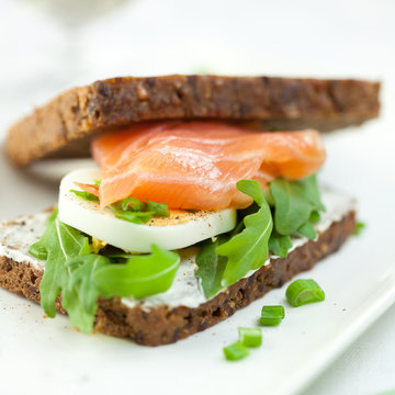 Closeup of sandwich with smoked salmon,egg and rocket