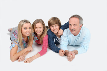 Obraz premium Happy family laying down the floor