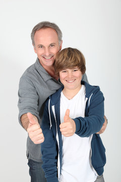 Father and son standing with thumbs up