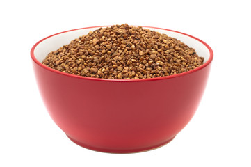 Soup plate with dry buckwheat isolated on white background