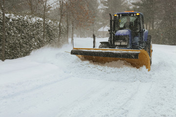 Snow plow cleaning street