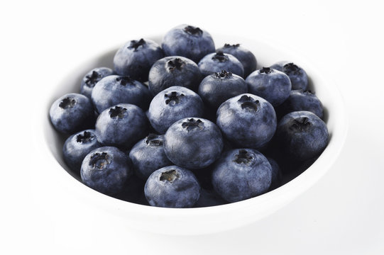 blueberry in white bowl on background