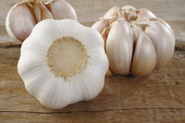 three garlic on wood background