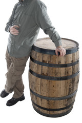 man leans on whiskey barrel