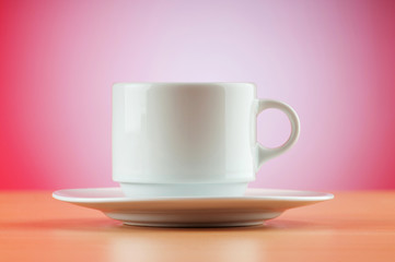Fototapeta na wymiar White cup against colourful gradient on the table