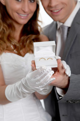 Bride and groom holding wedding rings