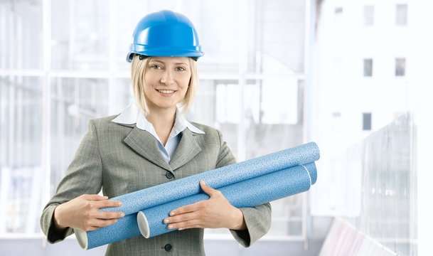 Happy architect woman with work plan