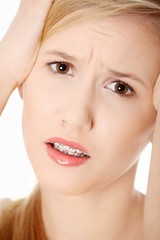 Obraz premium Woman with headache holding her hand to the head