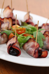Baked prunes in bacon