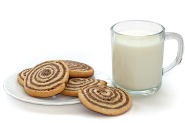 black and white cookies on the plate with cup of milk