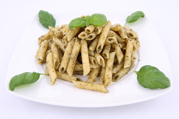 Penne with pesto decorated with basil