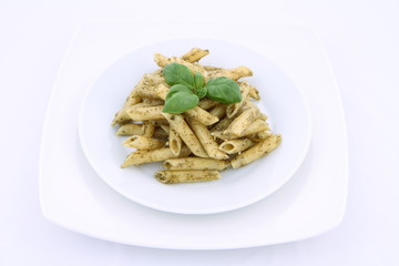 Penne with pesto decorated with basil