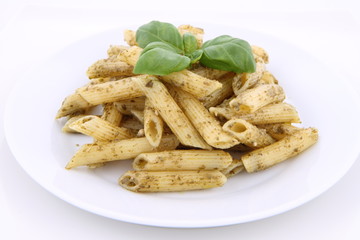 Penne with pesto decorated with basil