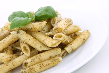 Penne with pesto decorated with basil