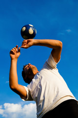 young man playing soccer