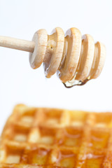 delicious Belgian waffles and stick to honey isolated on white