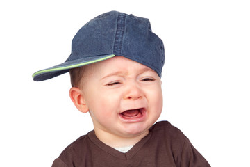 Beautiful baby crying with a cap