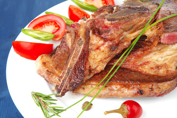 lamb meat fillet ready on china plate with tomatoes