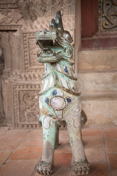 Dog-lion statue decorated with stones
