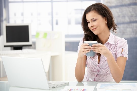 Attractive woman browsing internet in office
