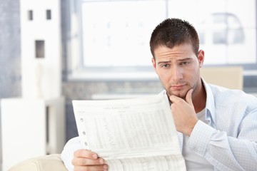 Young man reading bad news