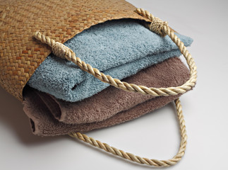 Towels in a straw bag.