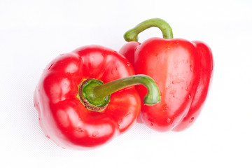 two red peppers on white background