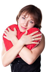 Beautiful young woman holding a heart