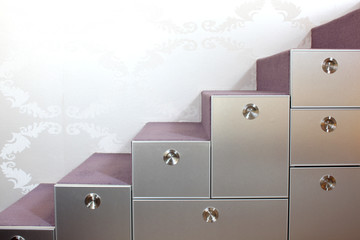 Stairs with carpet and drawers in the modern home