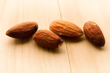 Almonds isolated on wooden background