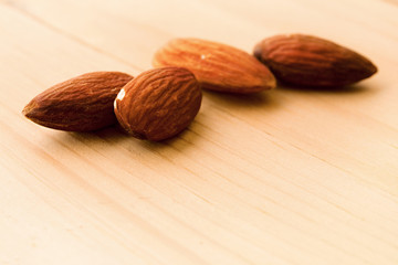 Almonds isolated on wooden background