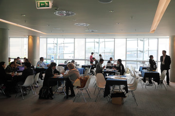 People sitting at discussion tables in meeting hall