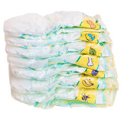 Disposable colorful baby diapers stacked over white background.