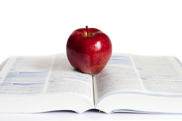 A red apple on a book