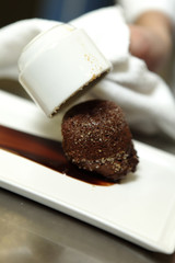 Chef in restaurant cooking a dessert