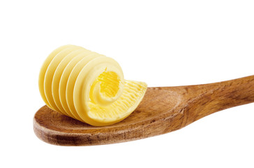 Butter curl on a wooden spoon - obrazy, fototapety, plakaty