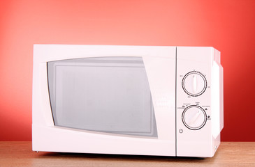 Microwave on red background